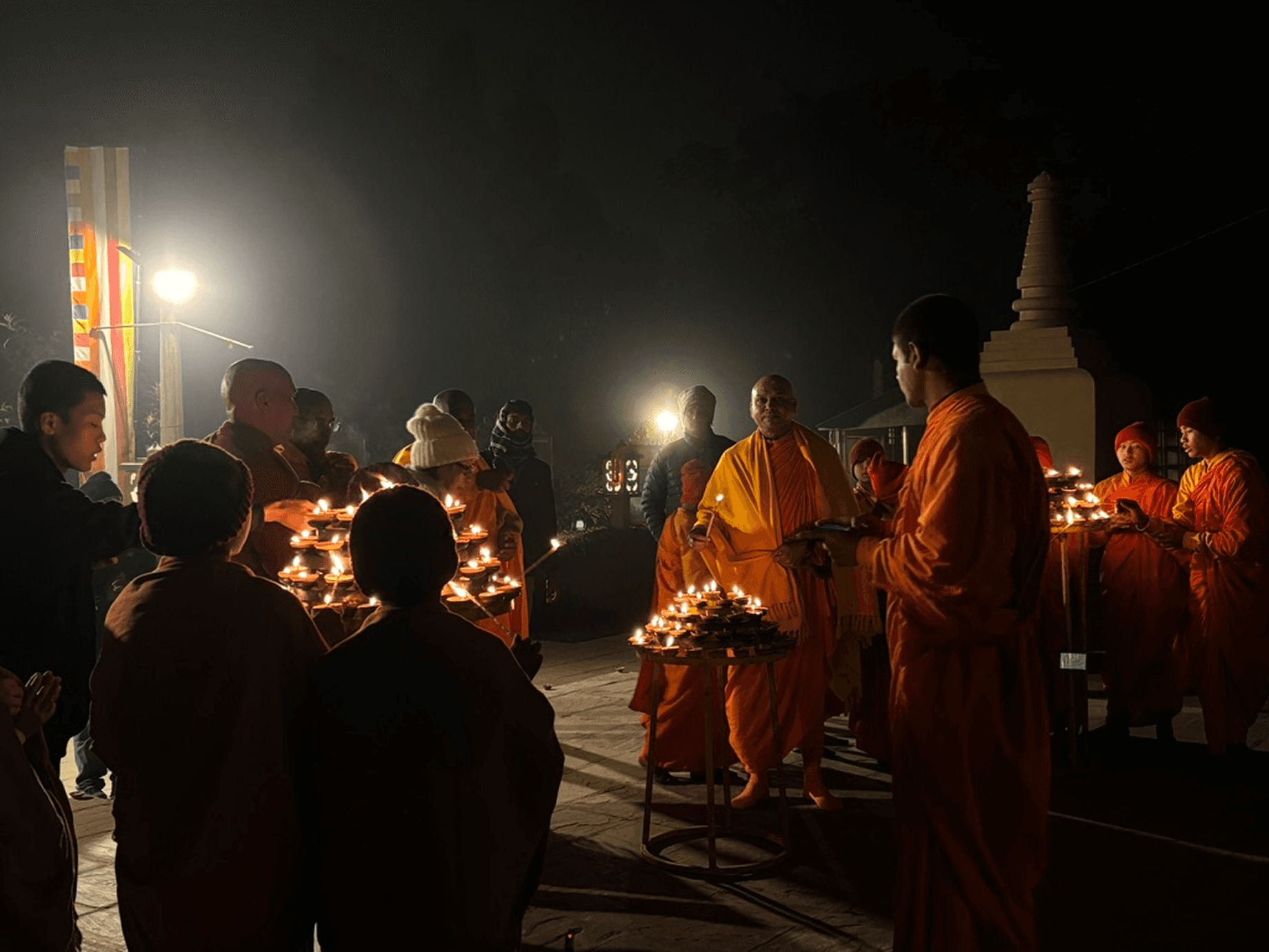 Buddhist monks performing the evening lamp lighting ritual