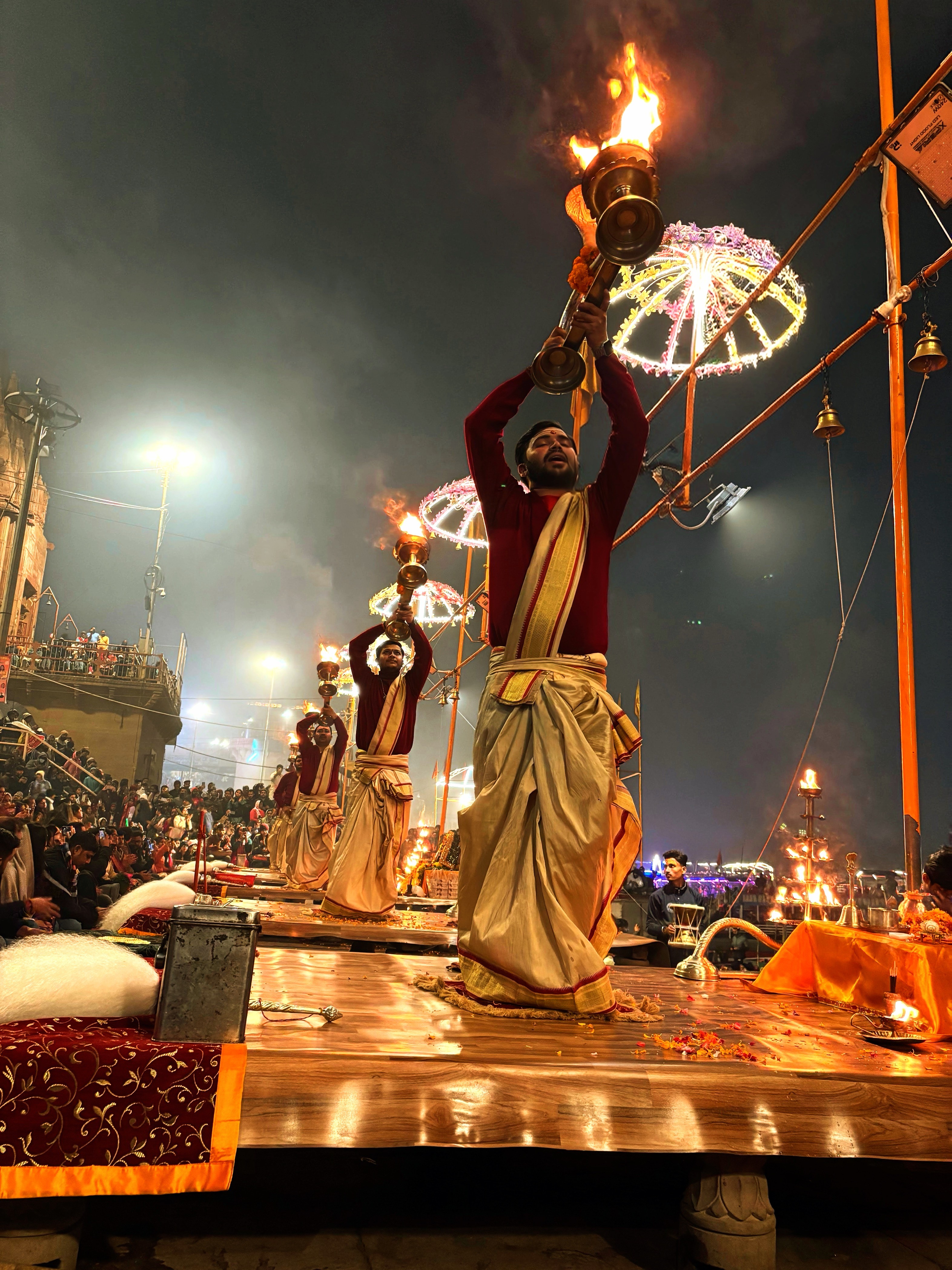 The contrast of flames of Ganga aarti and pyres at Manikarnika ghat