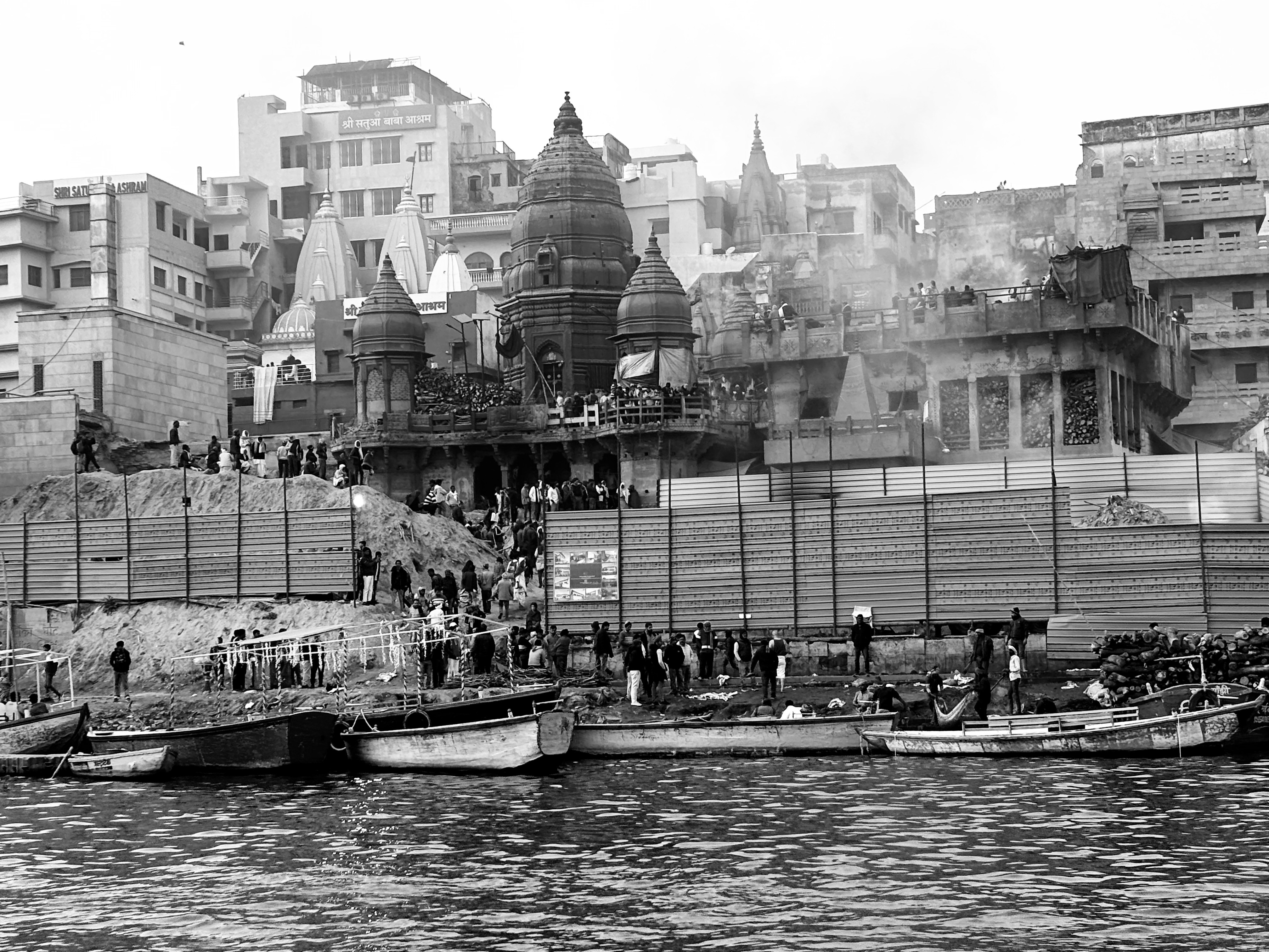 The contrast of flames of Ganga aarti and pyres at Manikarnika ghat